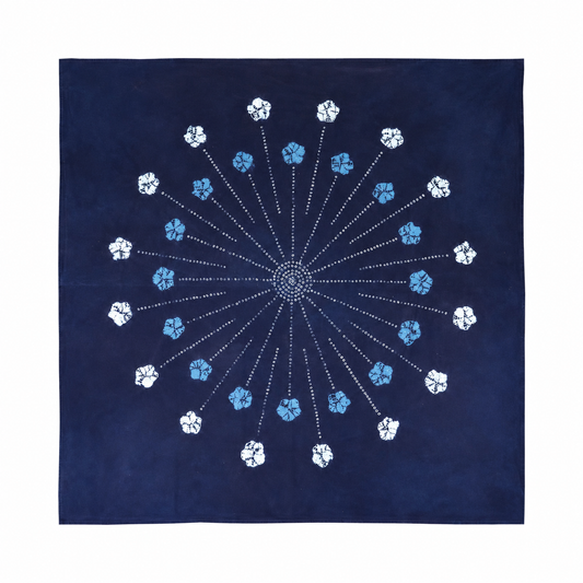 Large 110x110cm indigo tie-dye cotton mat featuring a central mandala firework pattern with radiant floral details, handcrafted Yunnan textile.