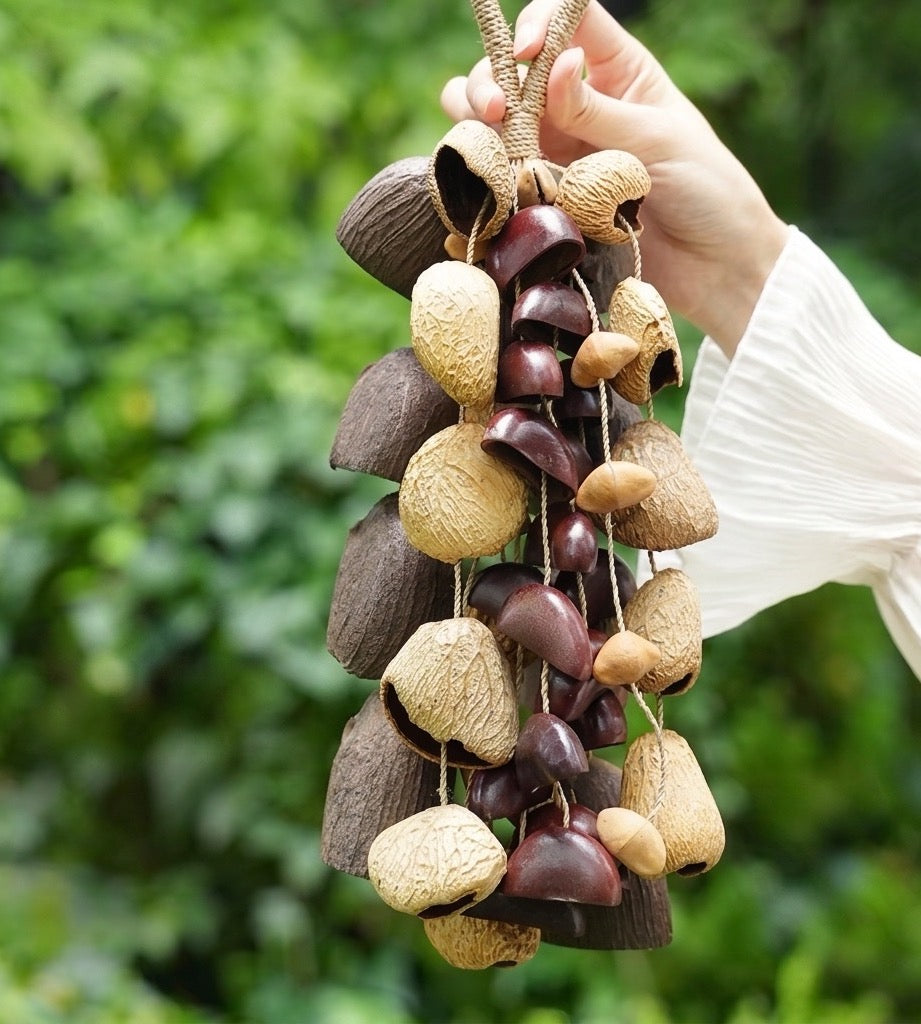 Handmade mixed fruit shells shaker in a lush forest setting, percussion instrument for meditation, sound healing, and rhythmic performance